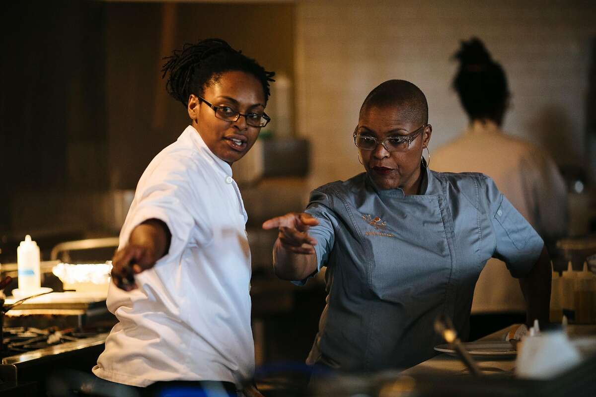 Tanya Holland, right, directs one her staff, LaKeha Pursley, to take an order at her restaurant, Brown Sugar Kitchen, in Oakland, Calif. Friday, November 10, 2017.
