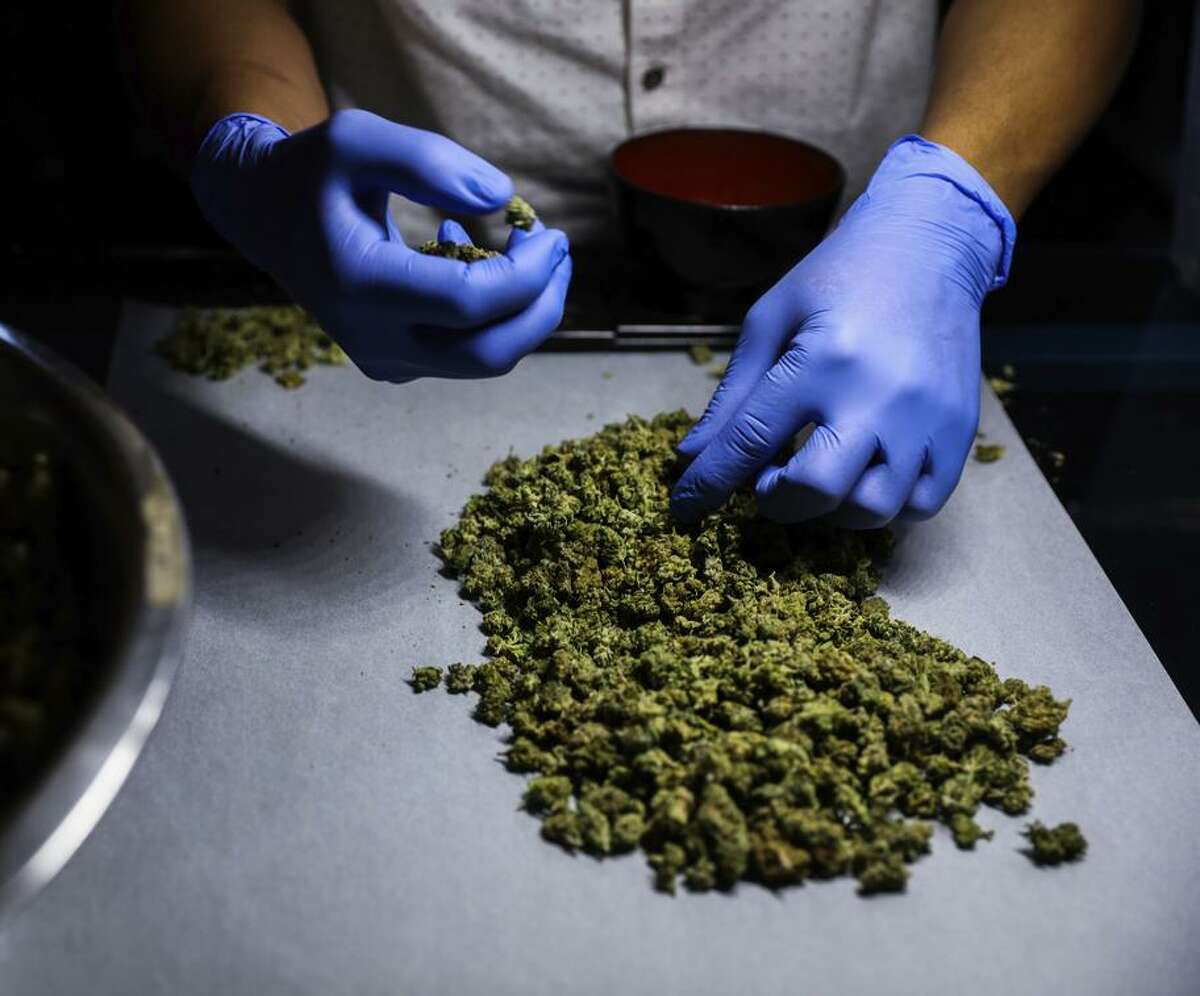 An employee sorts marijuana at the Green Cross cannabis dispensary in San Francisco’s Excelsior neighborhood.