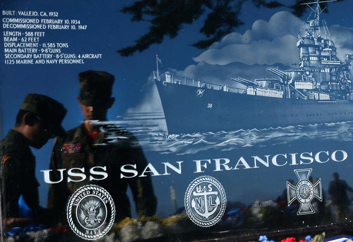 Joseph Consolino (left) and Tylaw Villacarlos, members of the Golden Gate Young Marines group, are reflected in a marble marker at the USS San Francisco Memorial while preparing wreathes for a Veterans Day ceremony to commemorate the 75th anniversary of the Battle of Guadalcanal in San Francisco, Calif. on Saturday, Nov. 11, 2017.