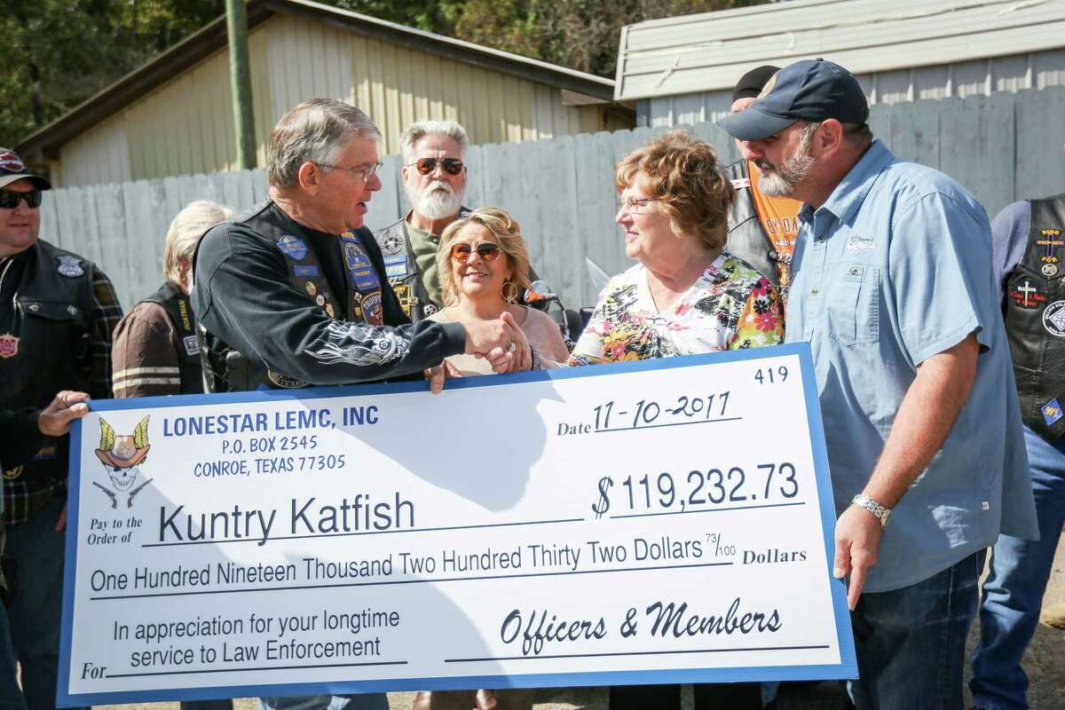 Don Fullen, captain with Precinct 1 Constable's Office and president of the Lone Star Chapter of the Reguladores Law Enforcement Motorcycle Club, left, shakes hands with Mary Bowers, owner of Vernon's Kuntry Katfish, accompanied by her daughter Debbie and her son Buster Friday at Vernon's Kuntry Katfish.