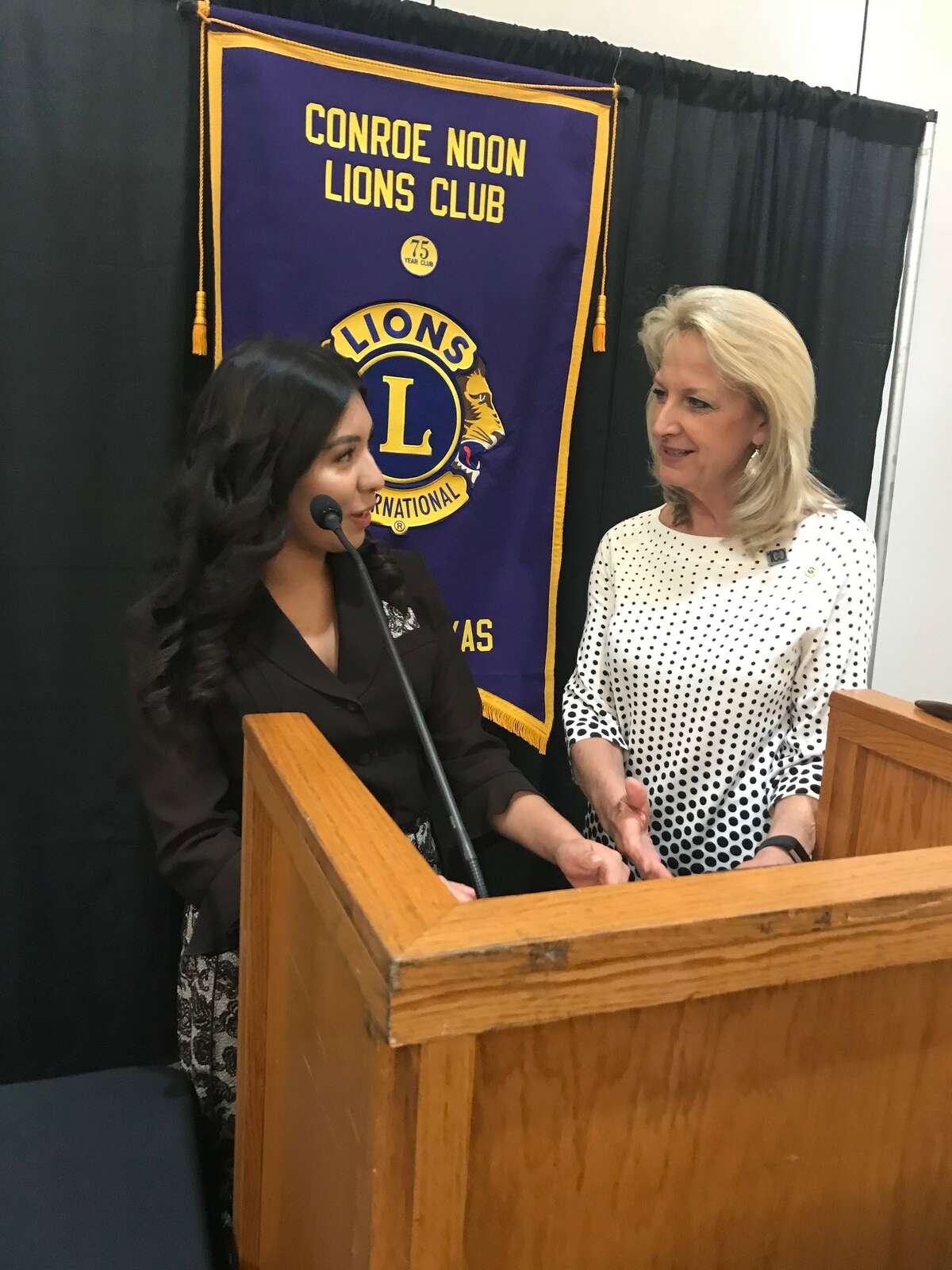 Scholarship winner Esly Saldivar, left, reviews her essay with Conroe Noon Lions Club President Helen Thornton, right, during the clubÂ?’s annual Diabetic Essay Contest.