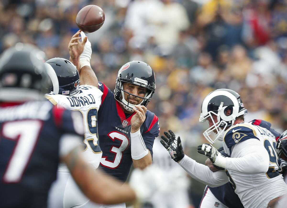 Houston Texans quarterback Tom Savage (3) has the ball knocked out of his hand by Los Angeles Rams defensive end Aaron Donald (99) during the second quarter of an NFL football game at the Los Angeles Memorial Coliseum on Sunday, Nov. 12, 2017, in Los Angeles. ( Brett Coomer / Houston Chronicle )