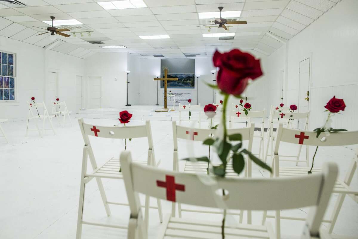 Roses on chairs with the names of those killed during the shooting at First Baptist Church in Sutherland Springs, Texas, which has been transformed into a memorial to honor those who died, Nov. 12, 2017. After a gunman killed 26 at the Baptist church one week ago, parishioners gathered at a nearby baseball field to worship with their pastor, whose daughter was among the dead. (Drew Anthony Smith/The New York Times)
