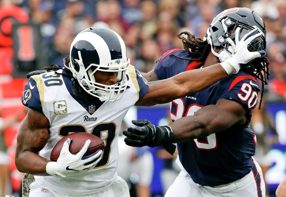 Los Angeles Rams running back Todd Gurley pushes away Houston Texans outside linebacker Jadeveon Clowney during the first half of an NFL football game, Sunday, Nov. 12, 2017, in Los Angeles. (AP Photo/Alex Gallardo)