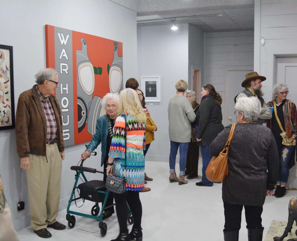 Guests for the grand opening of the Contemporary Art Museum of Plainview spend time talking with their fellow patrons and artists Friday evening.