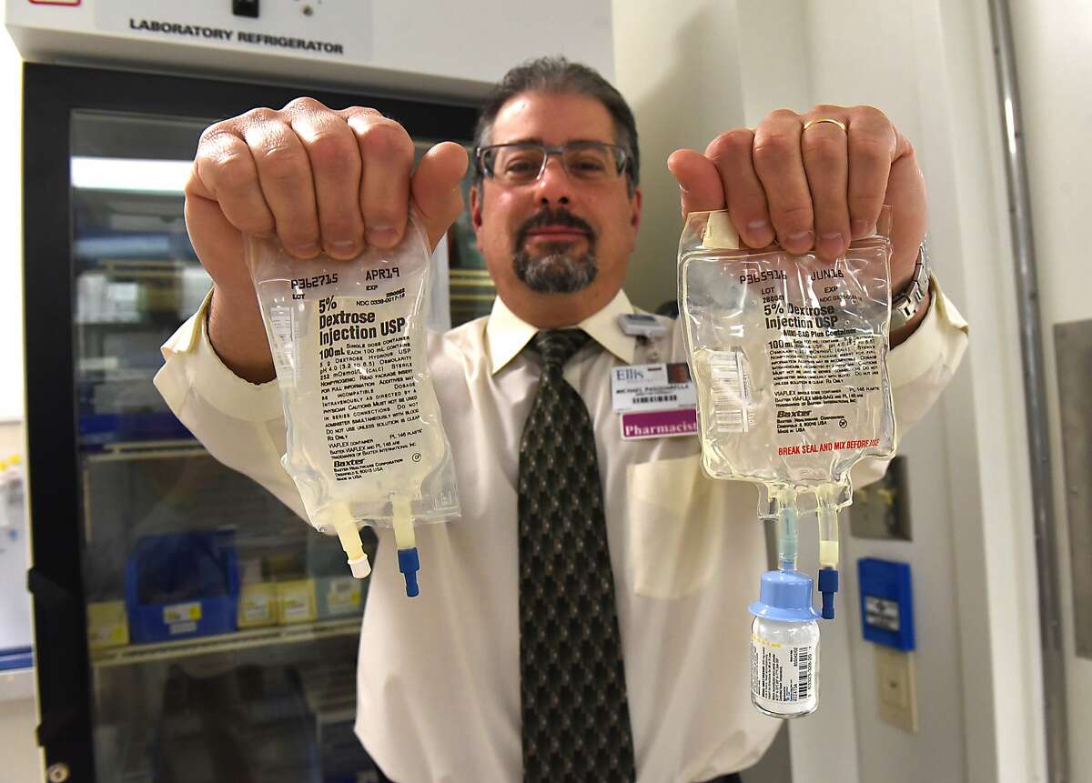 Mike Pasquarella holds up mini bags of IV fluid in the Ellis Hospital pharmacy on Tuesday, Oct 24, 2017 in Schenectady, N.Y. (Lori Van Buren / Times Union)
