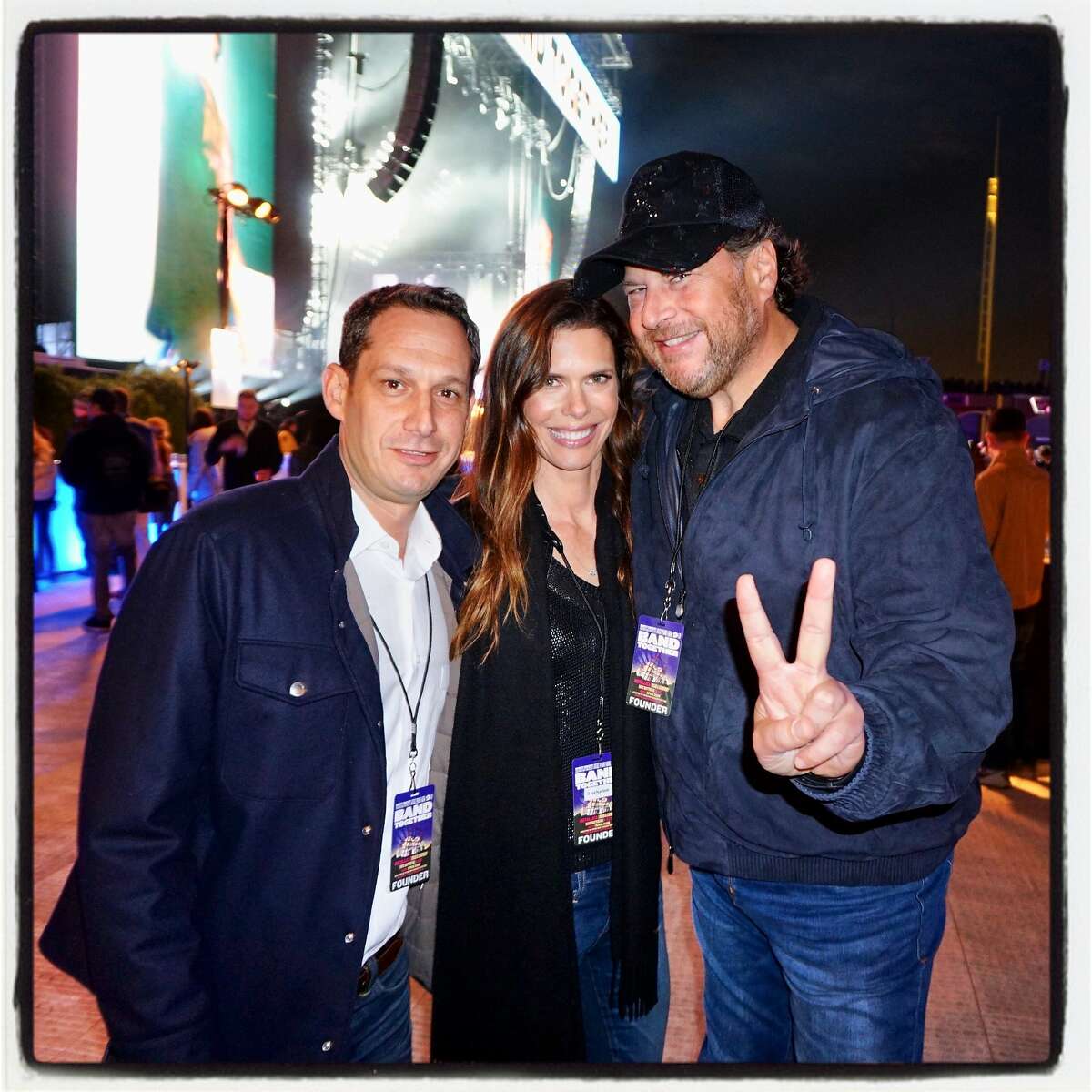 Tipping Point CEO Daniel Lurie (left) with philanthropist Lynne Benioff and her husband, Salesforce CEO Marc Benioff at AT&T Park for Band Together. Nov. 9, 2017.