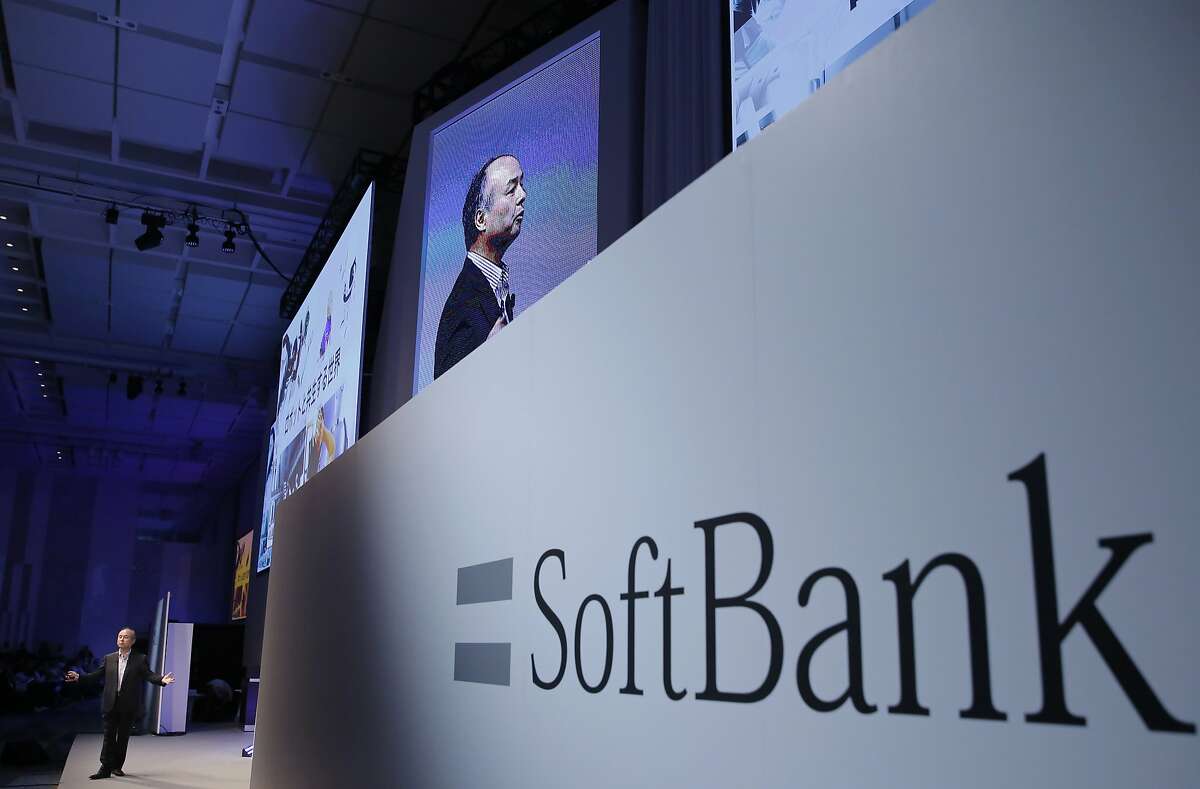 FILE - In this July 20, 2017, file photo, SoftBank Group Corp. Chief Executive Officer Masayoshi Son, left, speaks during a SoftBank World presentation at a hotel in Tokyo. Japanese technology conglomerate SoftBank has reached a deal with Uber to invest billions in the ride-hailing giant. Uber Technologies Inc. confirmed the investment in a statement Sunday, Nov. 12, without giving details. (AP Photo/Shizuo Kambayashi, File)