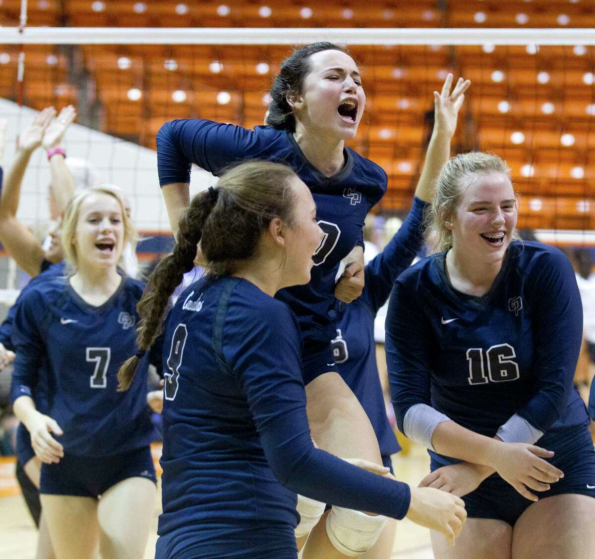 College Park players celebrate after their straight set victory over Klein Oak during a Region II-6A semifinal match at Johnson Coliseum, Friday, Nov. 10, 2017, in Huntsville.
