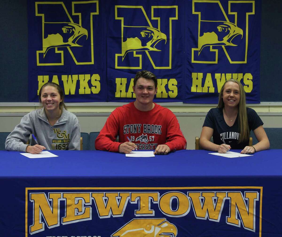 Newtown High School senior student-athletes, from left, Sarah Houle, Layton Harrell and Sara Kennedy, sign their National Letters of Ingtent to play their respective sports in college during a ceremony at the school Nov. 13, 2017. Houle will play golf at William and Mary, Harrell will play lacrosse at Stony Brook and Kennedy will play softball at Villanova.
