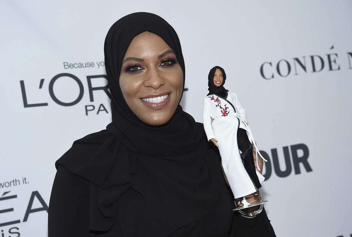 Ibtihaj Muhammad holds a Barbie doll in her likeness at the 2017 Glamour Women of the Year Awards in New York. 