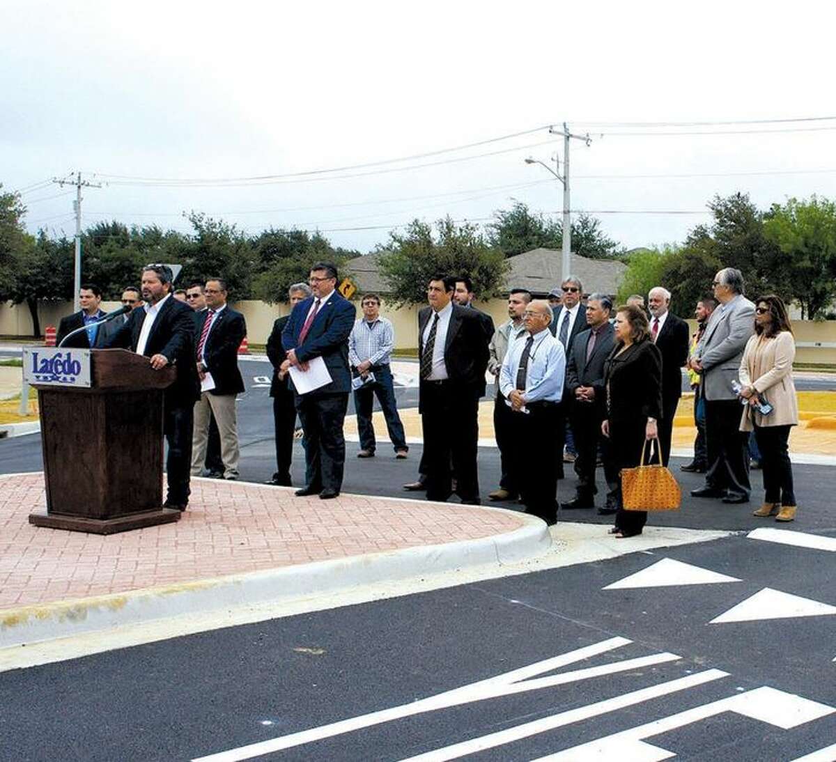City of Laredo Councilman Charlie San Miguel announces during a news conference Monday the opening of the newly reconstructed San Isidro Parkway and International Boulevard intersection that now has a roundabout. 