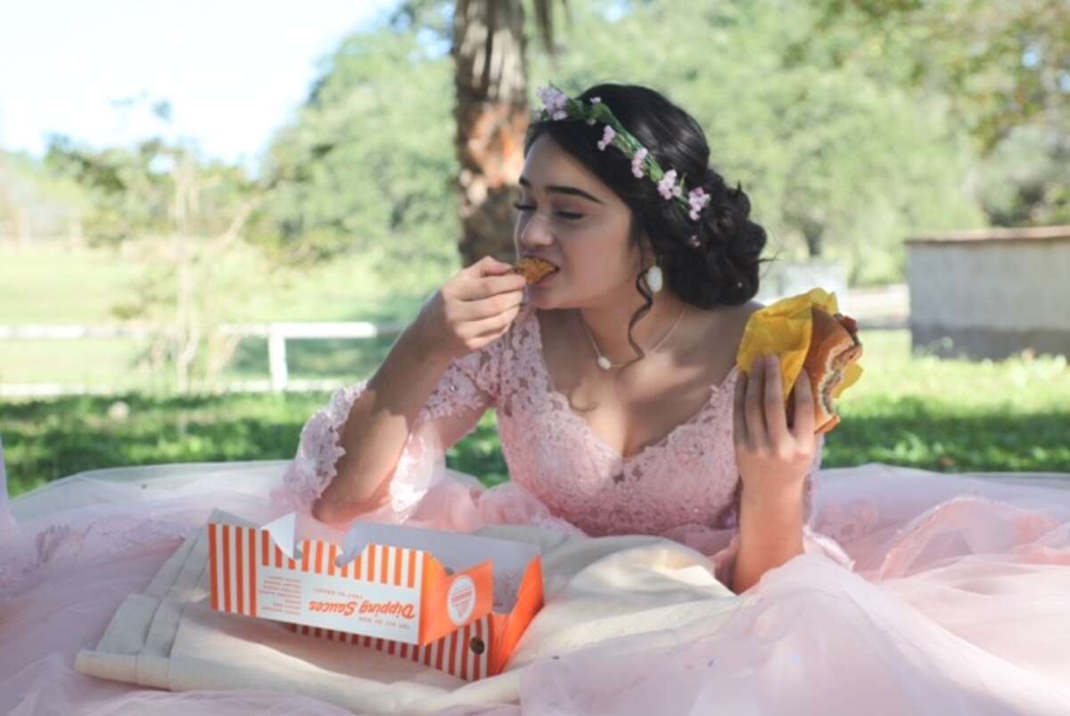 Evelyn Lopez Terrazas took birthday photos ahead of her quinceanera festivities in her quince ball gown and Texas accents, including cowgirl boots and of course, Whataburger.