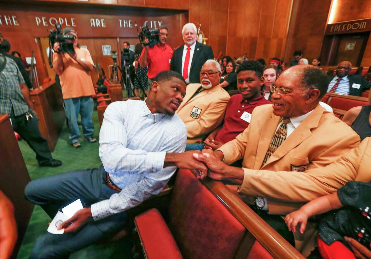 Andre Johnson, former Texans wide receiver, shakes hands with NFL Hall of Famers and chats with Elvin Bethea before he was honored with "Andre Johnson Day" by the City of Houston Tuesday, Nov. 14, 2017, in Houston.