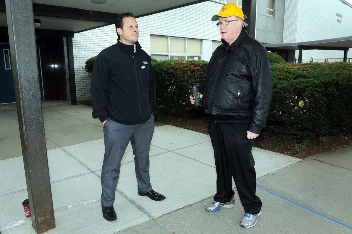 Michael DeFilippo, left, and Bob Keeley, both candidates for the 133rd City Council District, wait to greet voters outside of Blackham School in Bridgeport, Conn. Nov. 14, 2017.