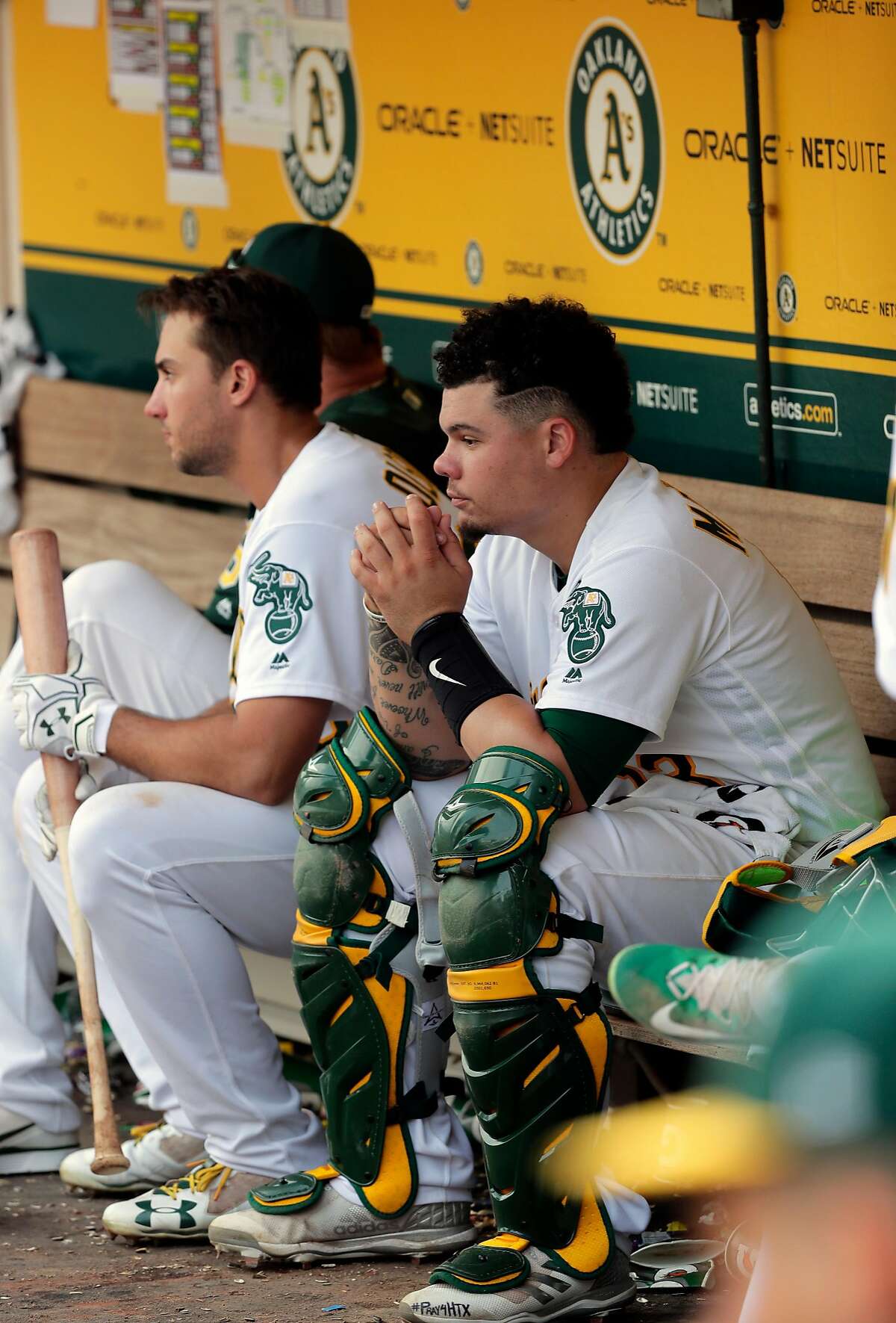 A's catcher Bruce Maxwell sits in the dugout in the 11th inning, as the Oakland Athletics take on the Los Angeles Angels at the Oakland Coliseum in Oakland, Ca. on Mon. September 4, 2017.