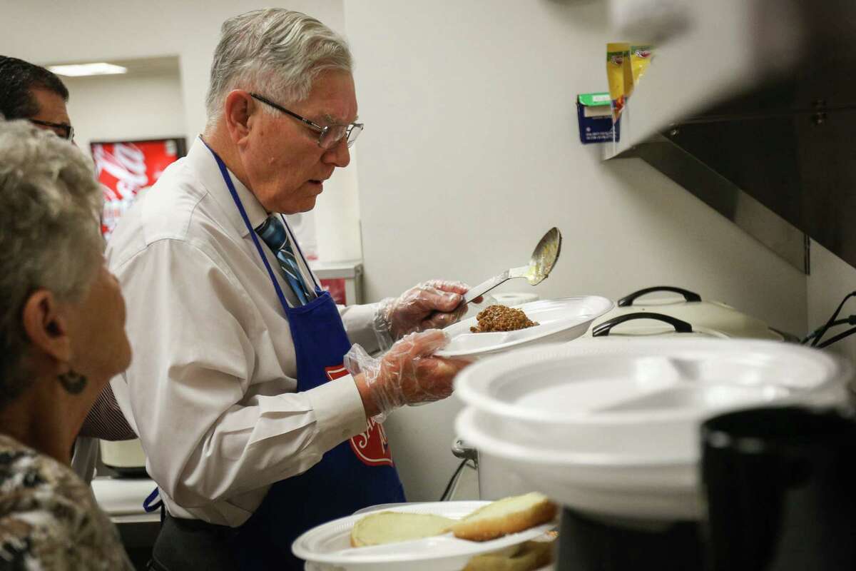 Conroe Mayor Toby Powell prepares lunches during the Empty Bowls Lunch on Tuesday, Nov. 14, 2017, at the Salvation Army.