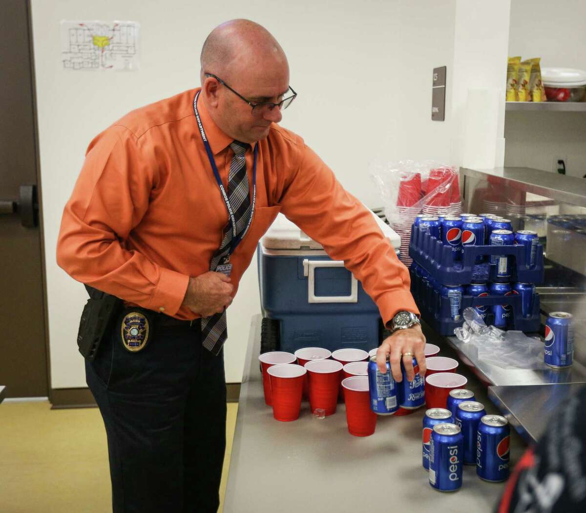 Conroe Police Chief Philip Dupuis lays out drinks for serving during the Empty Bowls Lunch on Tuesday, Nov. 14, 2017, at the Salvation Army.