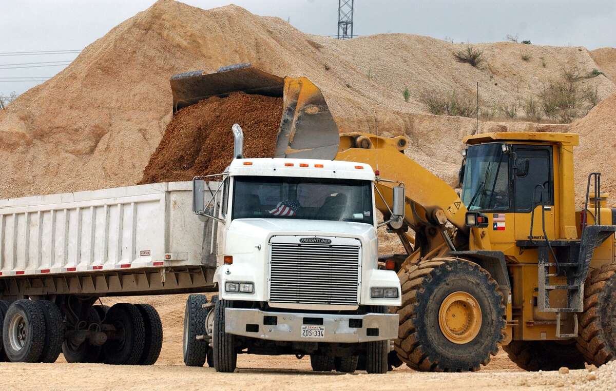 A front end loader loads up a customer truck with material form the Huebner Road Quarry. JOHN DAVENPORT / STAFF