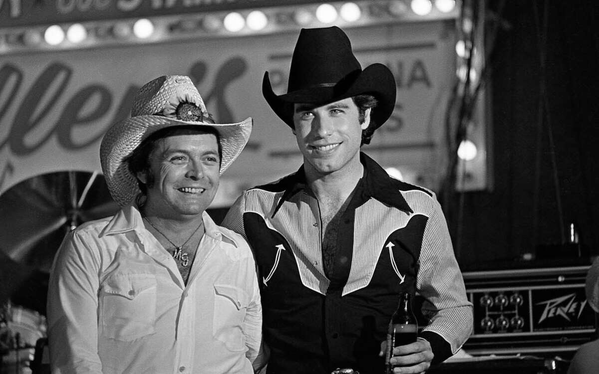 06/05/1980 - Mickey Gilley and John Travolta at Houston movie premiere party for "Urban Cowboy" at Gilley's club.
