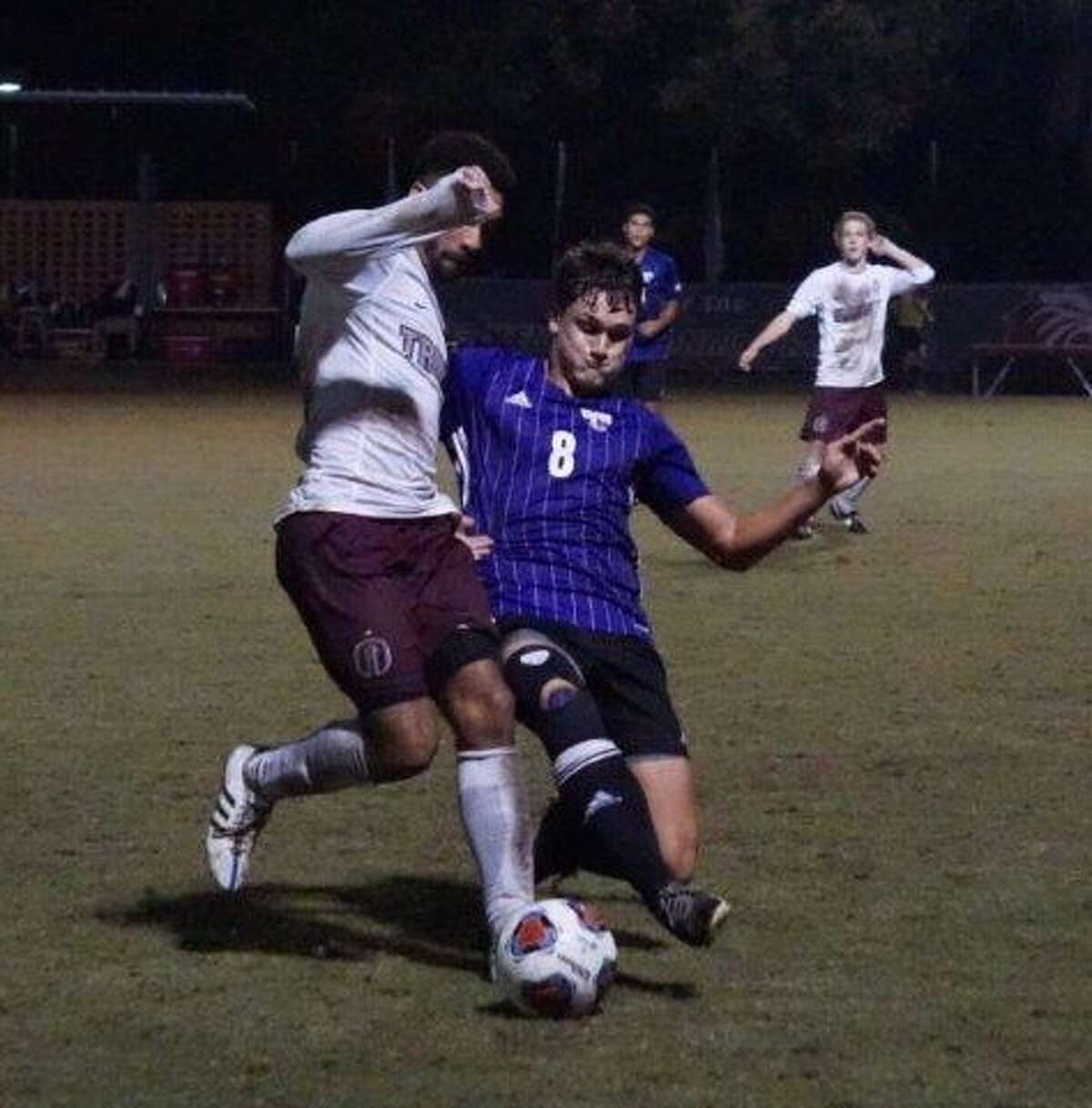 Mary Hardin-Baylor soccer player Logan Keeler, a Montgomery alum, and Trinity University's Wesley Mitchell, a The Woodlands alum, battle for the ball this past Saturday night in San Antonio.