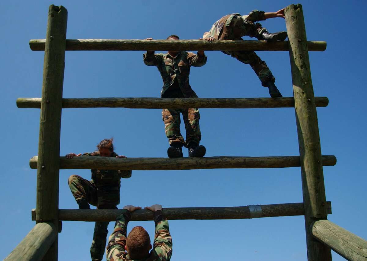 Army reservists from the 90th Regional Readiness Command maneuver their way through an obstacle course at Camp Bullis. Troops there had been preparing themselves for the types of warfare situations encountered in Iraq.