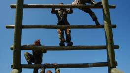 Army reservists from the 90th Regional Readiness Command maneuver their way through an obstacle course at Camp Bullis. Troops there had been preparing themselves for the types of warfare situations encountered in Iraq.