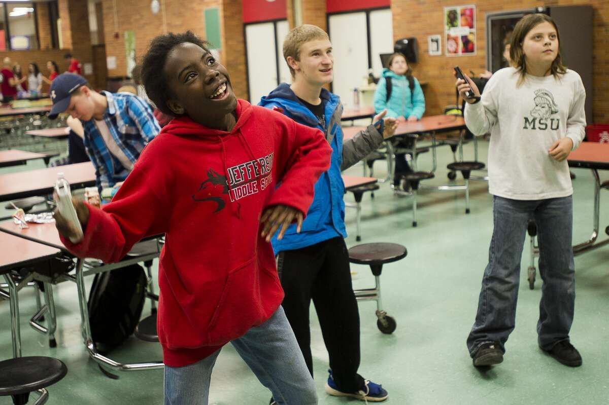 From left, Destiny Laws, 12, Tanner Bowerson, 16, and Bryson Bennett, 11, play Just Dance 2 on the Wii during The ROCK, a daily after-school program featuring snacks, tutors, crafts and games, on Wednesday, Nov. 15, 2017 at Jefferson Middle School. (Katy Kildee/kkildee@mdn.net)