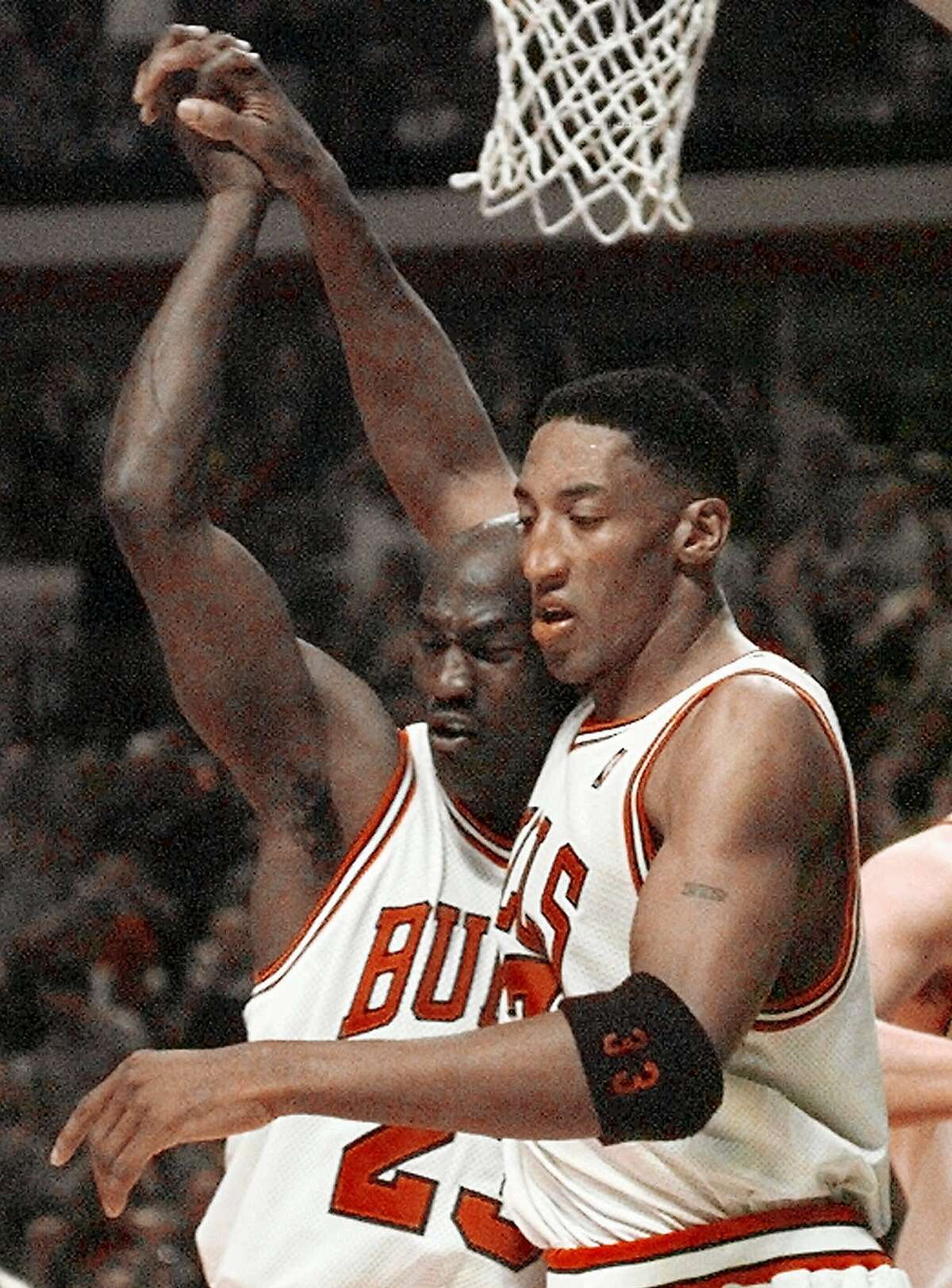Chicago Bulls' Michael Jordan (23) congratulates Scottie Pippen (33) after Pippen scored and drew a foul late in the fourth quarter of Game 7 of the Eastern Conference Finals Sunday, May 31, 1998, in Chicago. The Bulls defeated the Pacers 88-83 to advance to the NBA Finals against the Utah Jazz. (AP Photo/Fred Jewell)