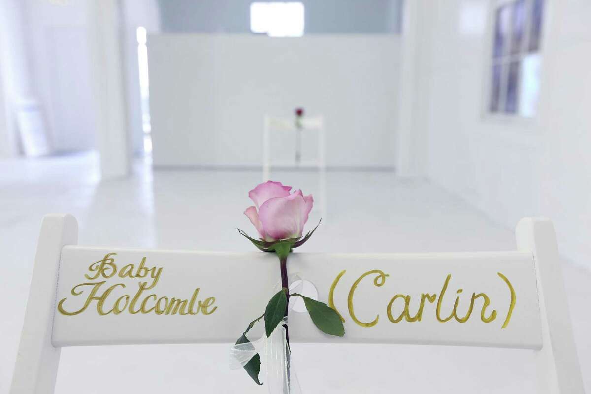 Red roses were placed on each chair except for one, which held a pink rose for the unborn child of John Holcombe and his wife Crystal, who died in the shooting. The couple had planned to name the baby Carlin Brite, according to a Facebook post from John Holcombe.