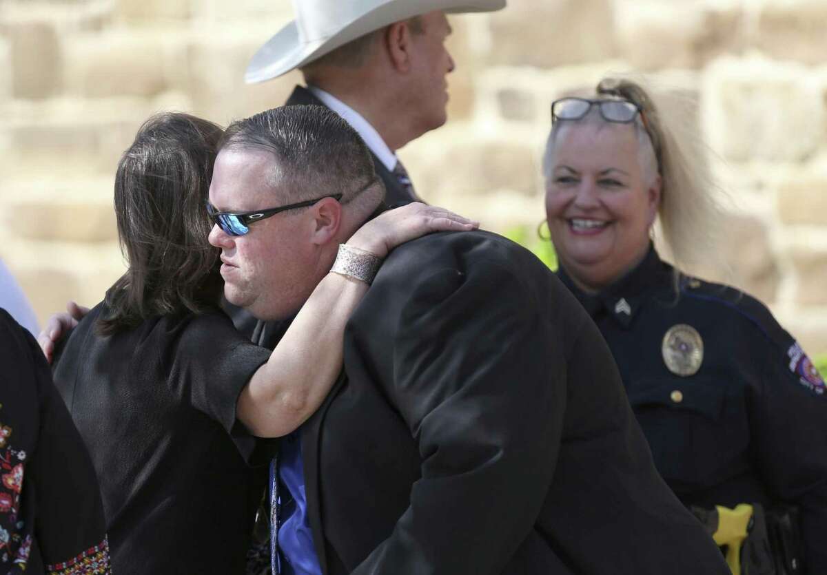 Mourners hug outside the Floresville Event Center Wednesday afternoon, Nov. 15, 2017 before the funeral of six members of the Holcombe family and three members of the Hill family that were killed in the Sutherland Springs church shooting that killed 26 people.