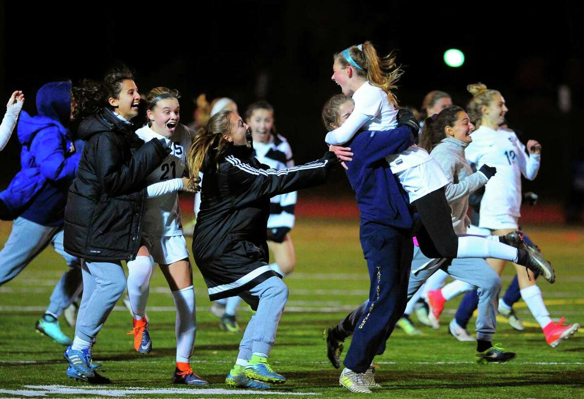 The Staples team celebrates its victory over Darien in Wednesday’s Class LL semifinal in Fairfield.