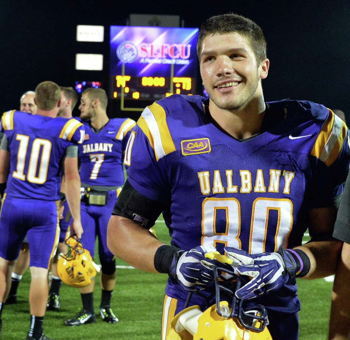 UAlbany's #80 Brian Parker is all smiles as he leaves the field after Saturday's season opener win against Holy Cross at Bob Ford Field in Albany, NY. (John Carl D'Annibale / Times Union)