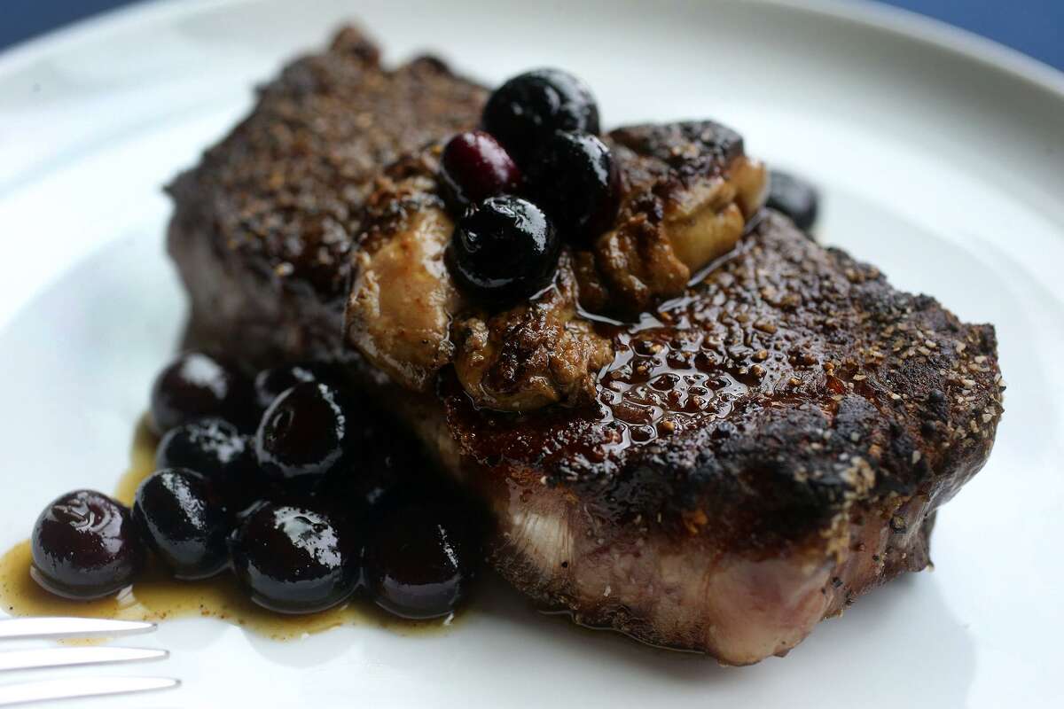 The New York strip steak with foie gras and pickled blueberries at Range