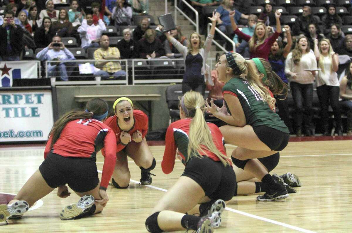 The Woodlands celebrates after defeating San Antonio Churchill in straight sets to win the Class 5A UIL Volleyball State Championship Saturday, Nov. 23, 2013, in Garland, Texas. The Woodlands became the 18th undefeated volleyball state champion in UIL history since 1967. To purchase this photo and other like it, visit HCNPics.com.