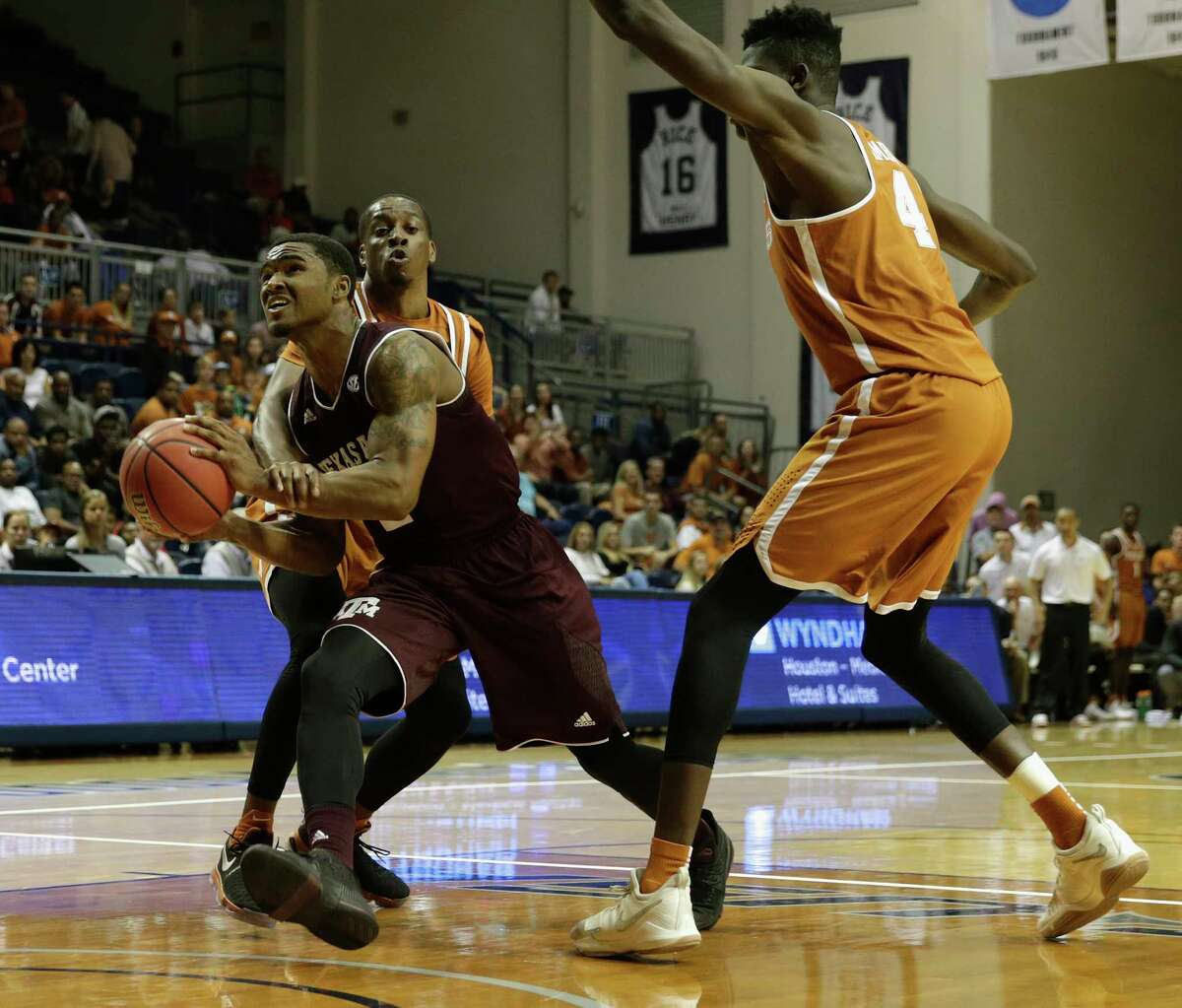 Texas A&M Aggies guard TJ Starks (2) is fouled by Texas Longhorns guard Matt Coleman (2) on the way to the basket in the second half during the exhibition basketball game between the Texas Longhorns and the Texas A&M Aggies to benefit the Rebuild Texas Relief Fund at Tudor Fieldhouse in Houston, TX on Wednesday, October 25, 2017.