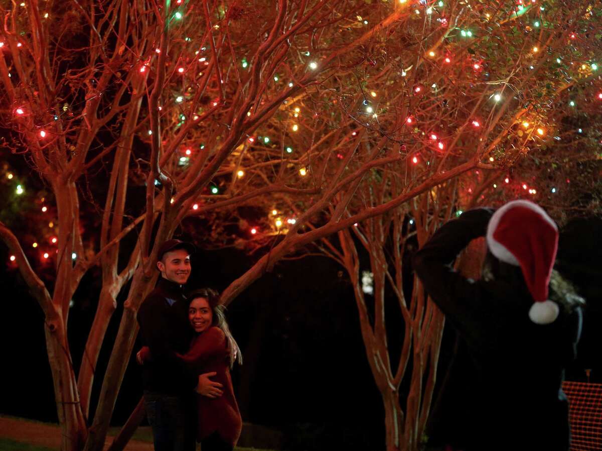 Bear Evans (left) and Kassya Gomez are photographed with the holiday lights by Violeta Sanchez after attending the University of the Incarnate Word’s 30th annual Light the Way event held last year.