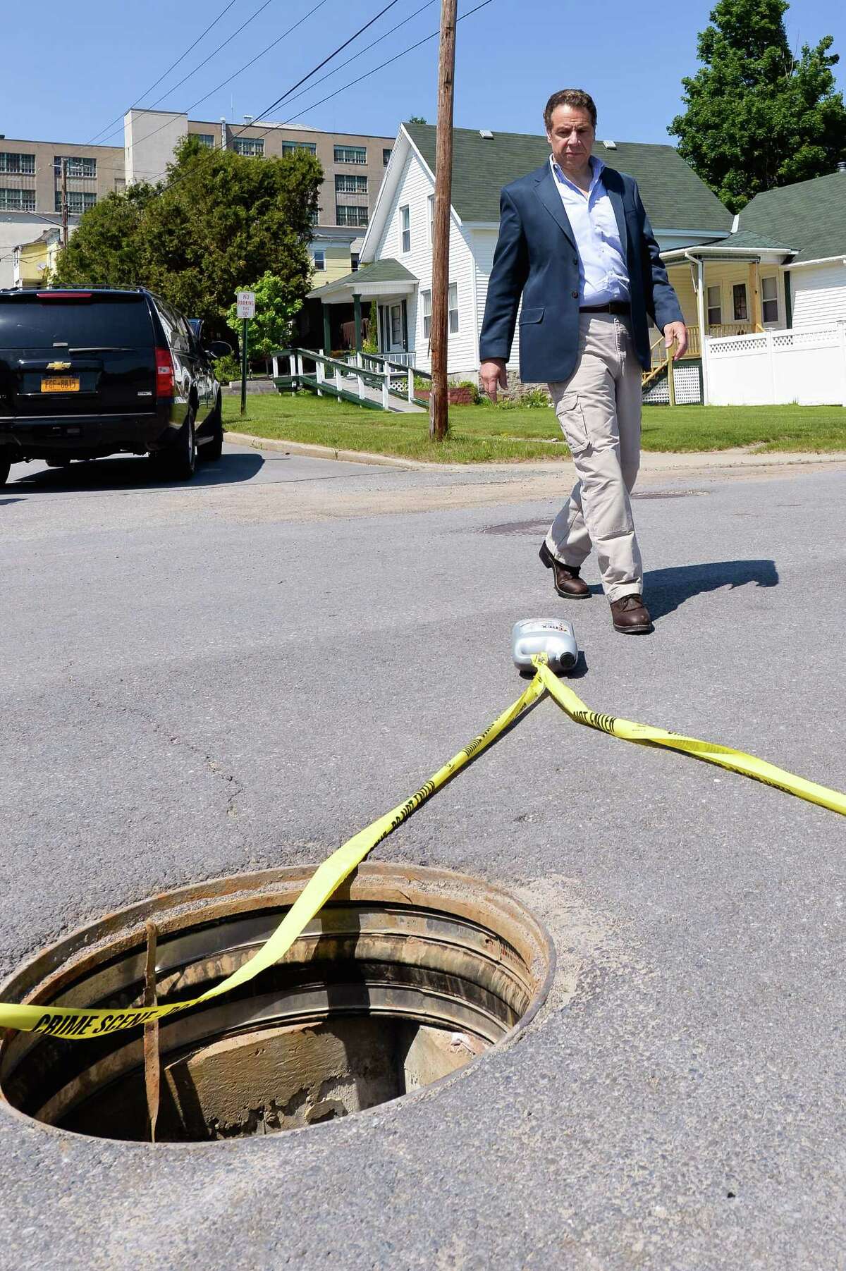 Gov. Andrew Cuomo is shown the manhole where two convicted murderers escaped from the Clinton Correctional Facility June 6, 2015.  (Photo by Darren McGee/New York State Governor's Office via Getty Images)