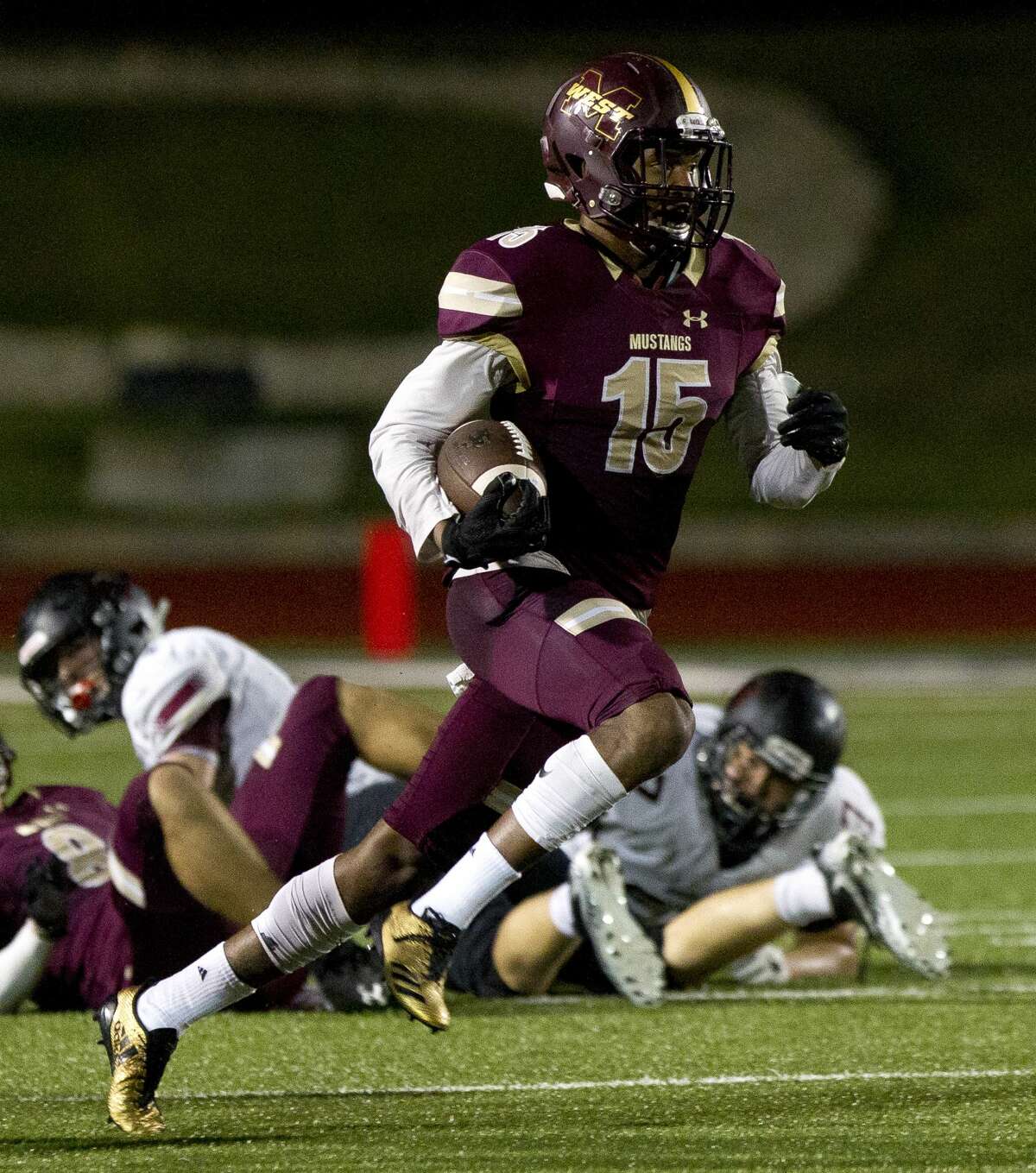 Magnolia West cornerback Ryan Franks (15) return the ball after intercepting a pass from Rouse quarterback Ethan Moore (18) during the second quarter of a Region III-5A bi-district high school football game at Merrill Green Stadium, Friday, Nov. 17, 2017, in Bryan.