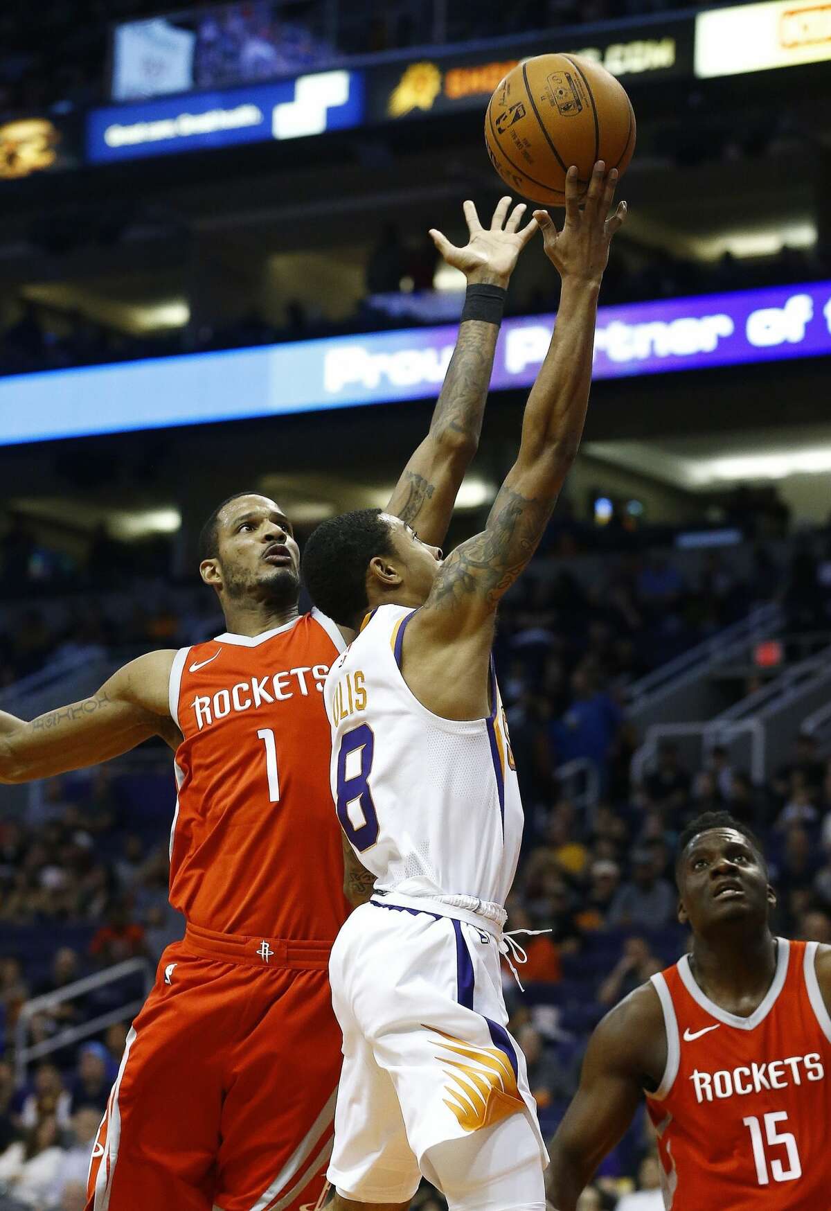 Houston Rockets forward Trevor Ariza (1) jumps to block the shot of Phoenix Suns guard Tyler Ulis (8) as Rockets center Clint Capela (15) watches during the second half of an NBA basketball game Thursday, Nov. 16, 2017, in Phoenix. The Rockets defeated the Suns 142-116. (AP Photo/Ross D. Franklin)