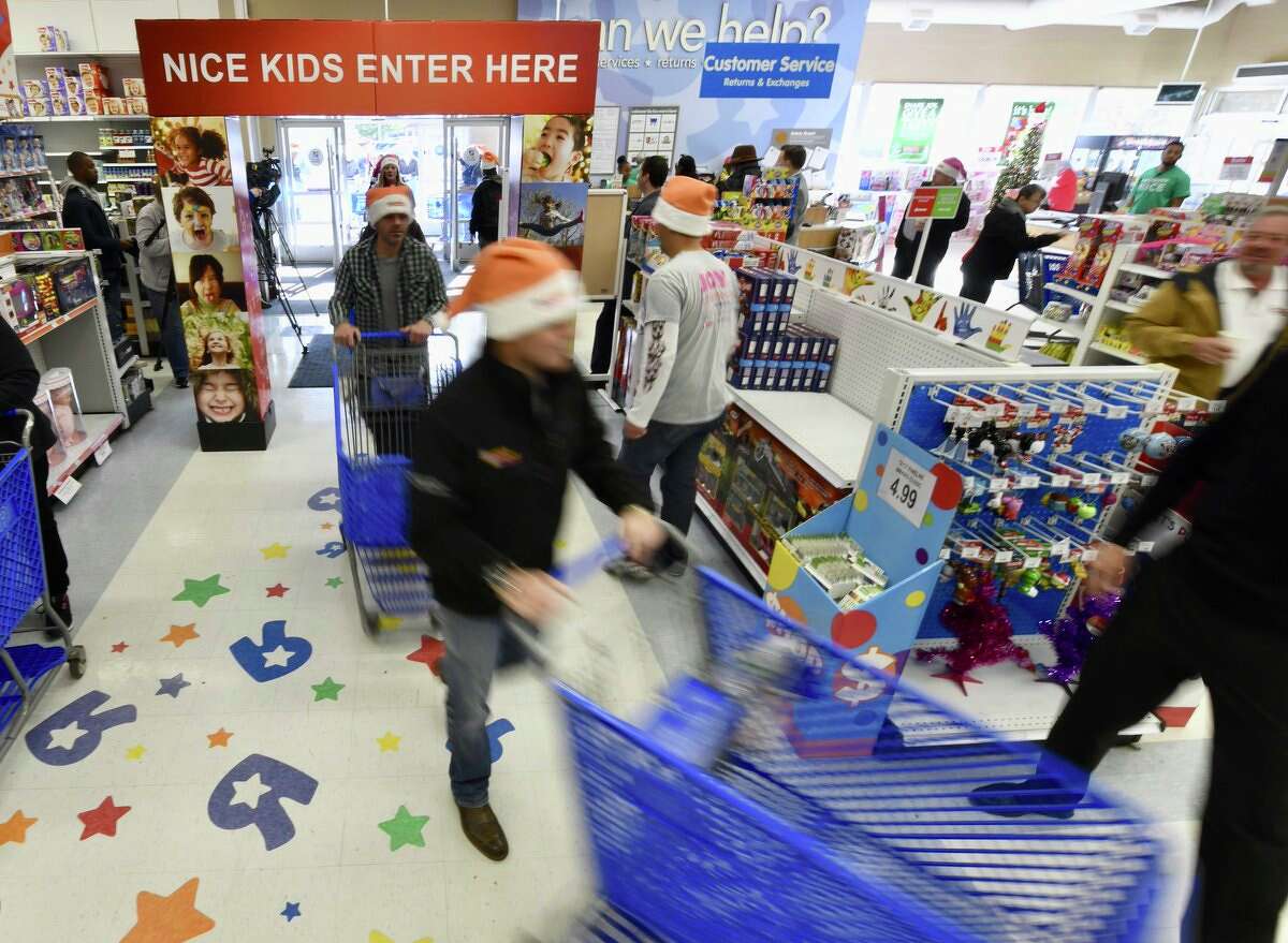 Volunteers ran through Toys "R" Us on Friday, Nov. 17, 2017, in a shopping spree for the U.S. Marine Corps Reserve Dunkin' Donuts Toys for Tots Train annual trip. (Skip Dickstein/Times Union)