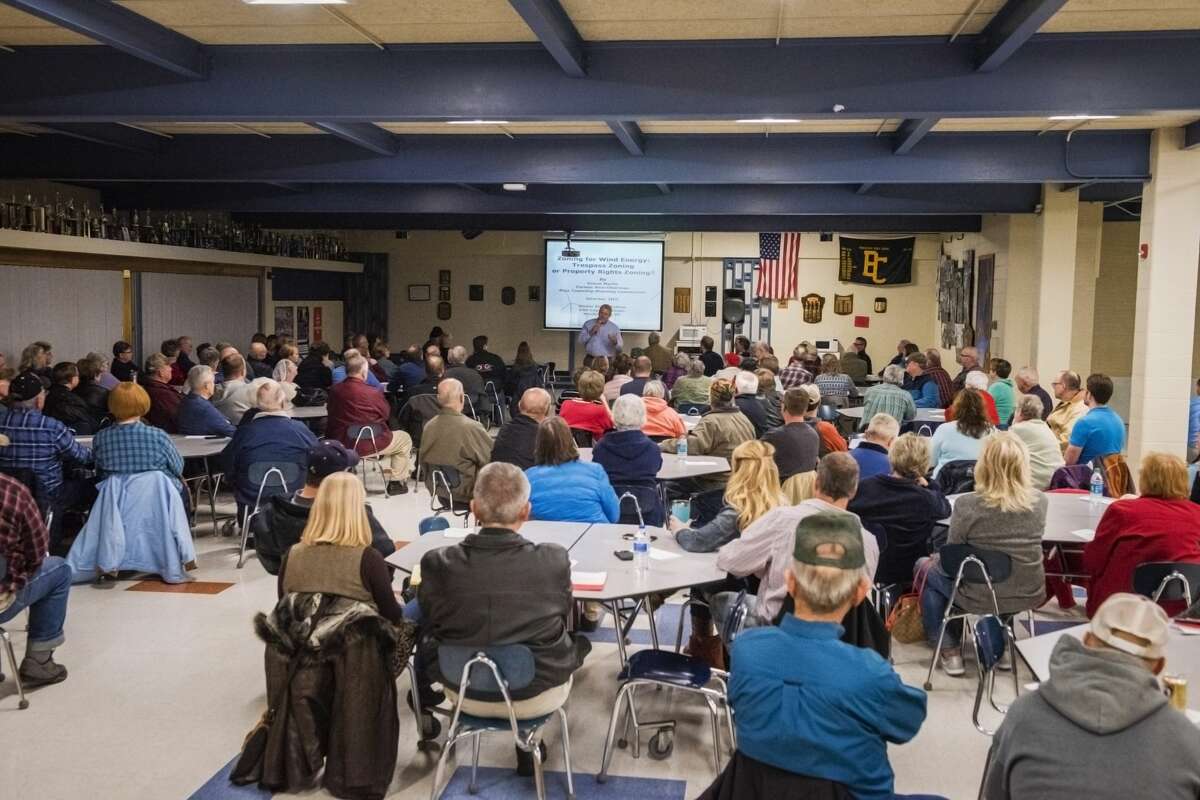 Attendees listen to a presentation about potential hazards and nuisances from turbines during a wind energy informational meeting sponsored by Ingersoll Township Concerned Citizens, on Thursday at Bullock Creek High School (Danielle McGrew Tenbusch/for the Daily News)