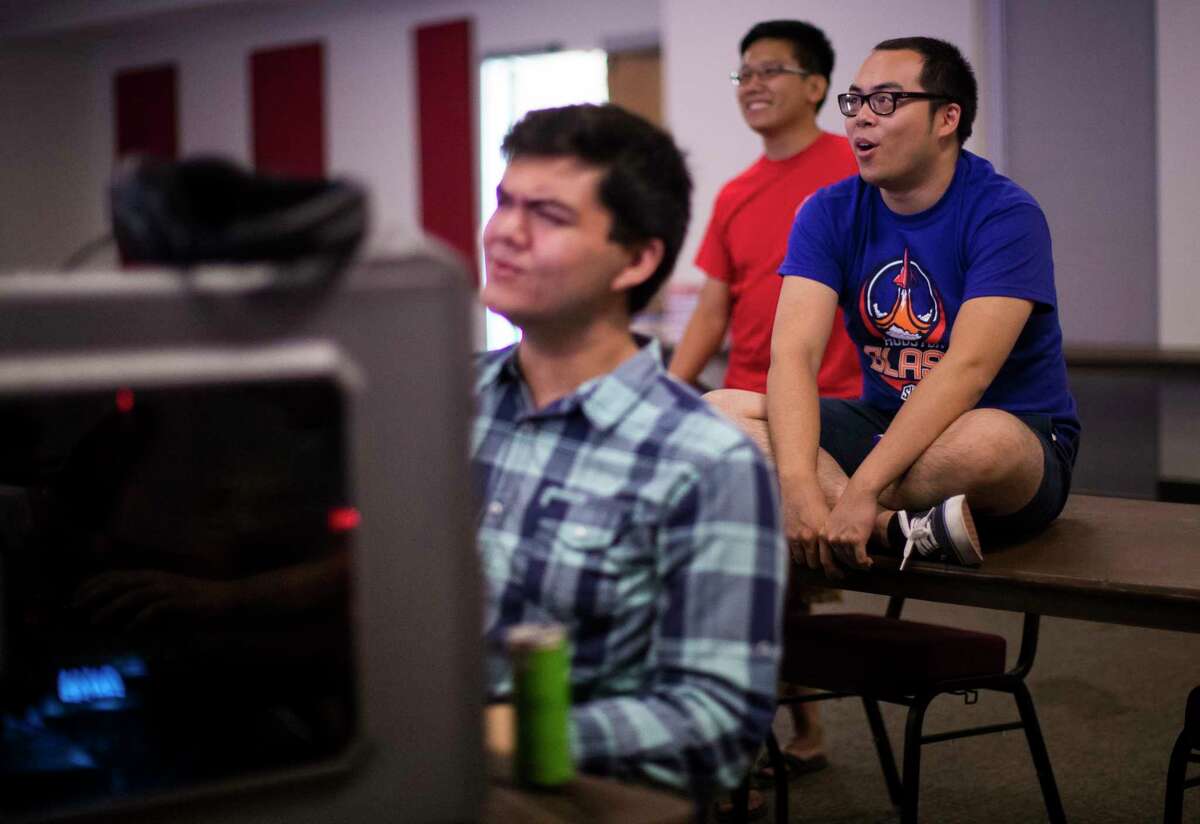 Nicholas Johnson, 20, Jimmy Chan, 22, co-Founder and president of eSports at University of Houston and Khanh Trimh, 30, react as the watch the Overwatch World Cup 2017 semi-finals match, Saturday, Nov. 4, 2017, in Houston. ( Marie D. De Jesus / Houston Chronicle )
