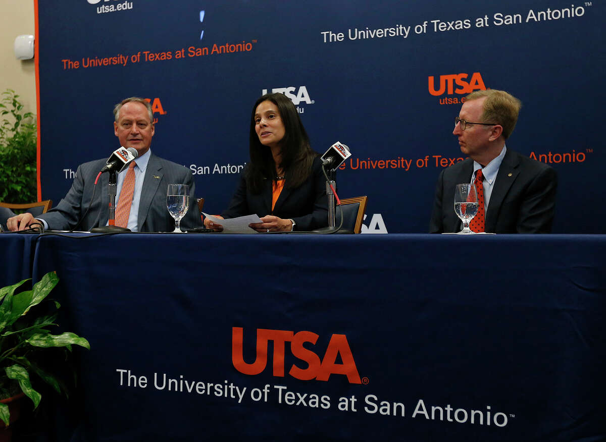 UTSA's new athletics director Lisa Campos (center) speaks as UTSA president Taylor Eighmy (left) Frost Bank president Pat Frost listen during a press conference held Friday Nov. 17, 2017 at the campus.