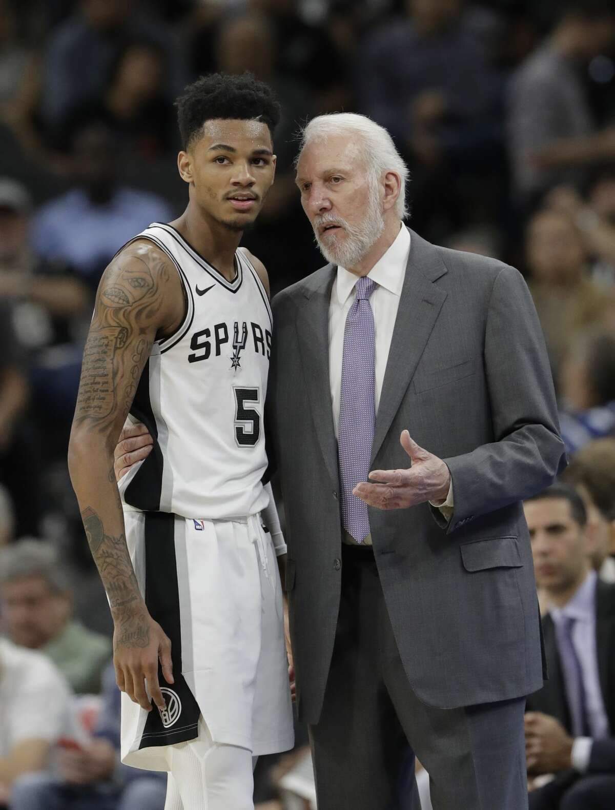 San Antonio Spurs coach Gregg Popovich, right, talks with guard Dejounte Murray during the first half of an NBA basketball game against the Oklahoma City Thunder, Friday, Nov. 17, 2017, in San Antonio. (AP Photo/Eric Gay)