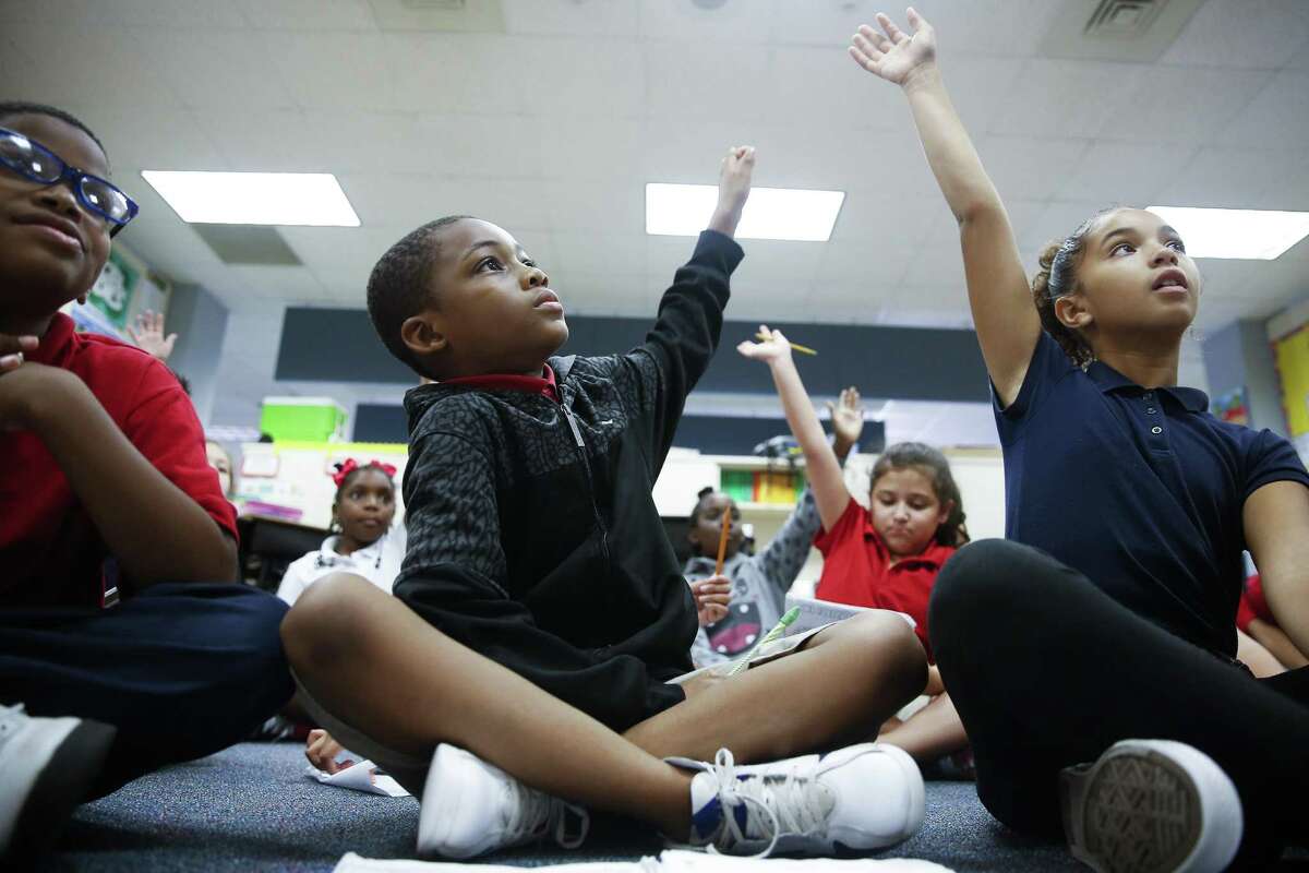 Outley Elementary third grader Antwon Patrick, 9, center, participates in a lesson with his classmates Wednesday, Oct. 4, 2017 in Houston. Patrick, along with 19 other students, started attending Outley after they were displaced by Hurricane Harvey. ( Michael Ciaglo / Houston Chronicle)