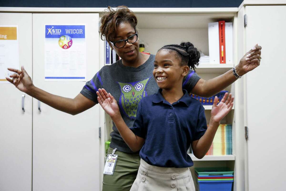 Outley Elementary third grade teacher Myra Yorke dances with Breanna Calvin, 8, Wednesday, Oct. 4, 2017 whose home was damaged during Hurricane Harvey in Houston. Outley has 20 new students at the school because of the hurricane. ( Michael Ciaglo / Houston Chronicle)