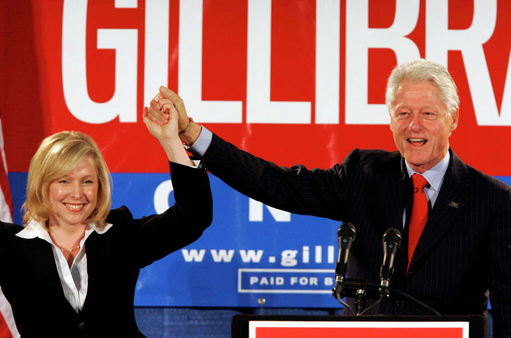 Former President Bill Clinton holds up the hand of Kirsten Gillibrand, a Democratic lawyer who is running against three-term Rep. John Sweeney, R-N.Y., at a rally in Albany, N.Y. on Oct. 26, 2006. Sen.
