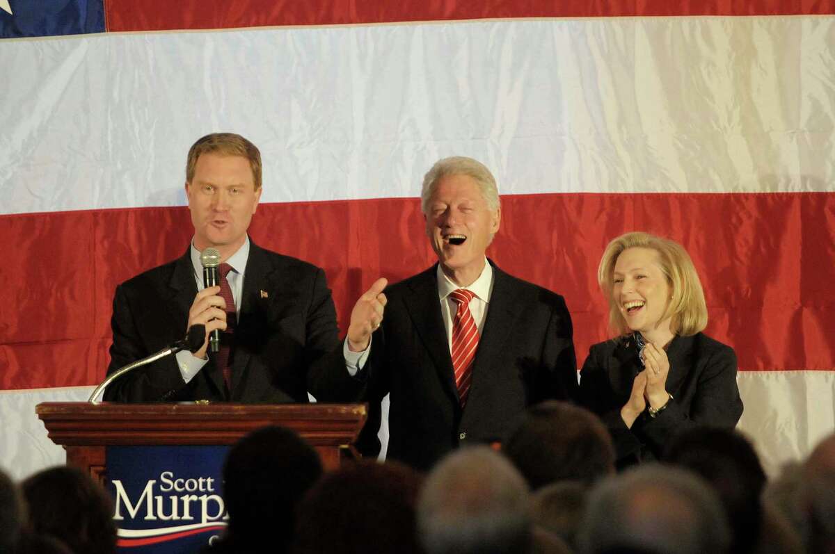 U.S. Congressman Scott Murphy, left, talks about stumping for former President Bill Clinton, center, when he was first running for President as U.S. Senator Kirsten Gillibrand, right, looks on, during a political rally at the Hall of Springs in Saratoga Springs, NY on Monday morning, Nov. 1, 2010. (Paul Buckowski / Times Union)