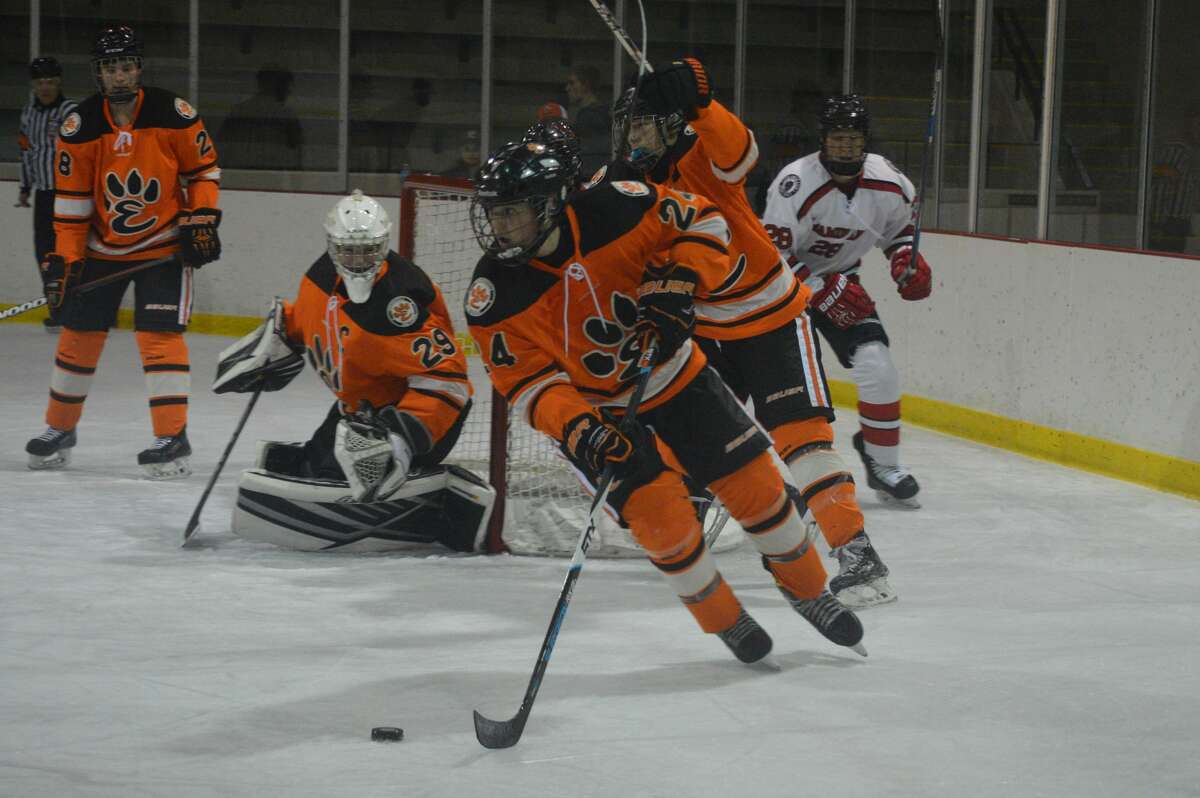 Edwardsville defenseman James Akeman controls the puck in his own zone during the second period of Friday's game against Chaminade at the Queeny Park Recreational Complex.